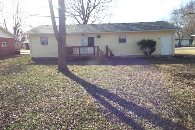 rear view of house featuring a yard and a wooden deck