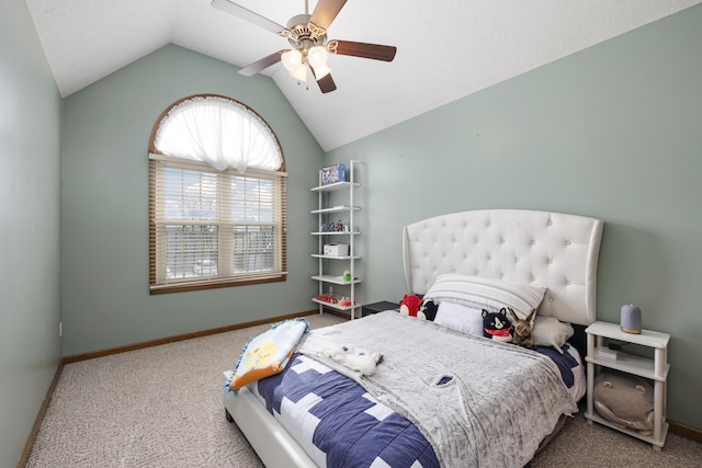 carpeted bedroom with vaulted ceiling, baseboards, and ceiling fan