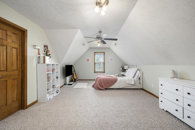 bedroom featuring light carpet, ceiling fan, a textured ceiling, and lofted ceiling