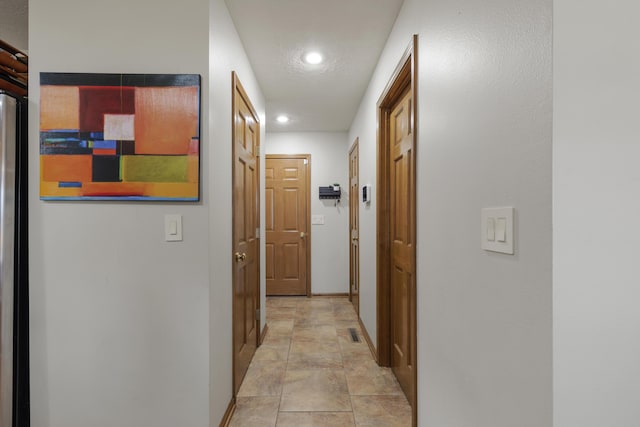 hallway with recessed lighting and baseboards