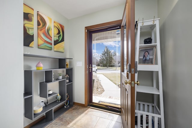 doorway to outside with baseboards