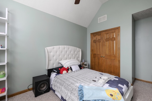 bedroom featuring carpet, a closet, visible vents, vaulted ceiling, and baseboards