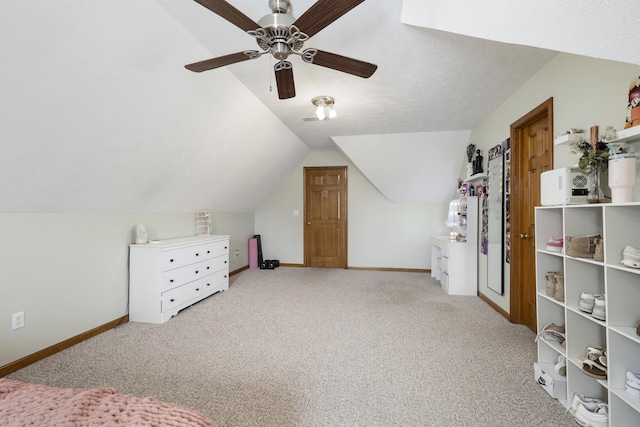 additional living space with a ceiling fan, carpet, vaulted ceiling, and baseboards