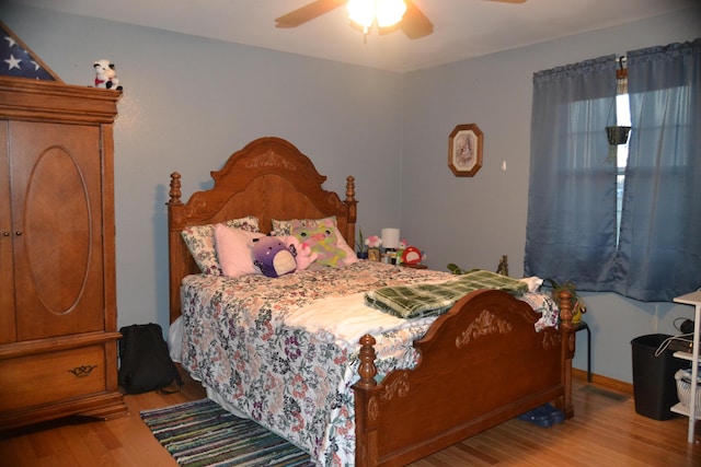 bedroom with wood finished floors and a ceiling fan