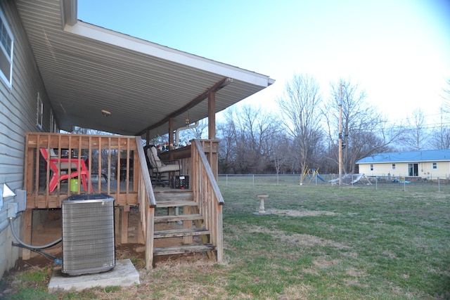 view of yard with cooling unit, a wooden deck, and fence