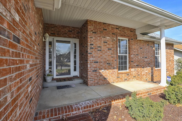 doorway to property with brick siding