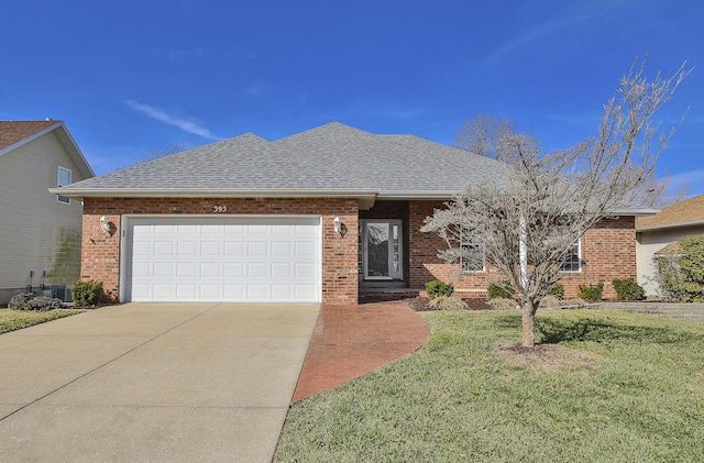 single story home with a shingled roof, a front yard, concrete driveway, and brick siding