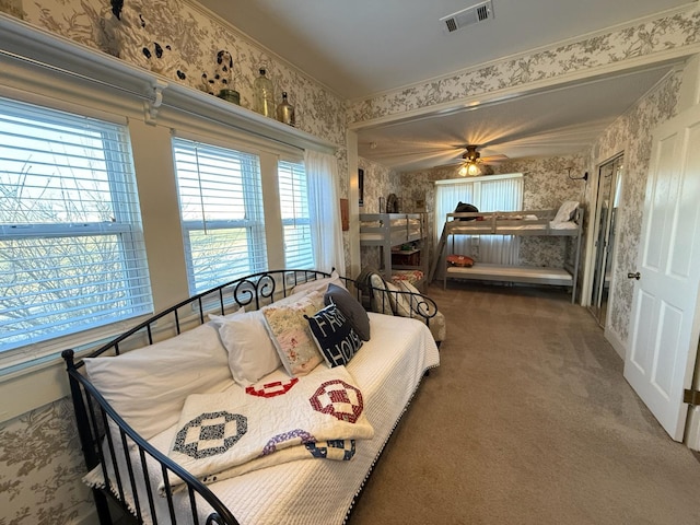 bedroom featuring carpet, visible vents, and wallpapered walls