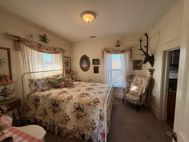 bedroom with visible vents and carpet flooring