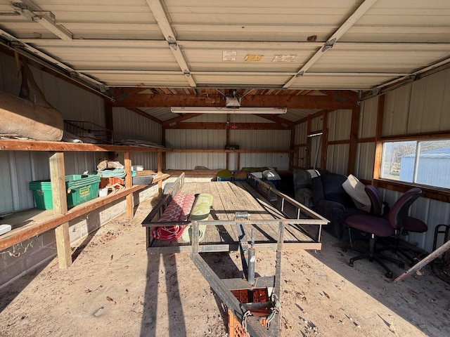 garage featuring metal wall and a garage door opener