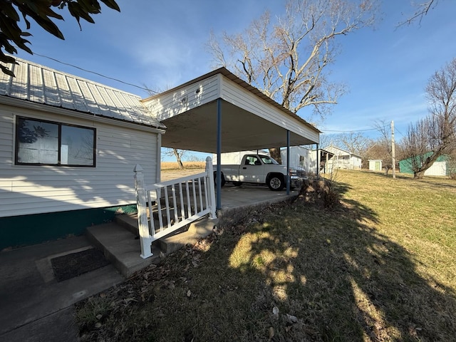 view of side of property featuring metal roof and a yard