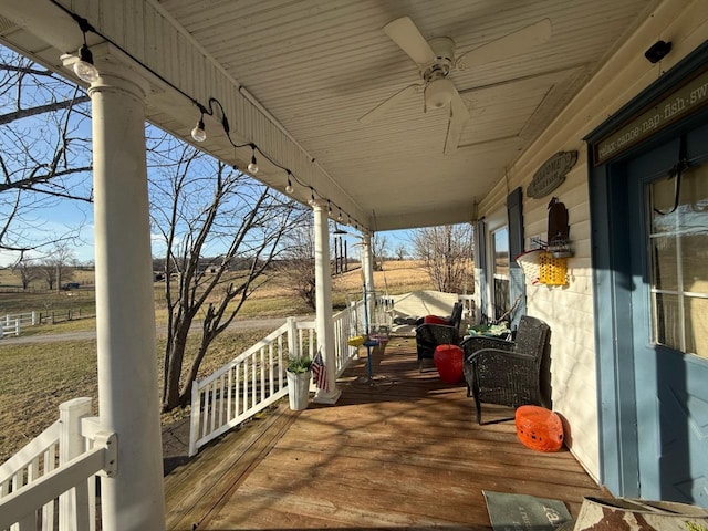 wooden terrace with a porch and a ceiling fan