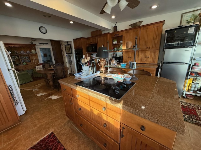 kitchen featuring tile counters, brown cabinets, black appliances, open shelves, and recessed lighting