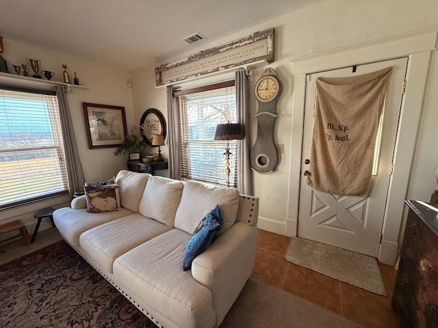 living area featuring visible vents and tile patterned floors