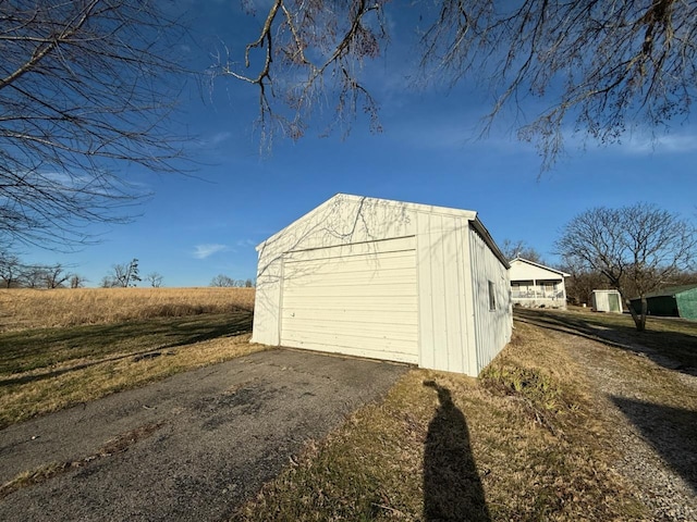 detached garage featuring driveway