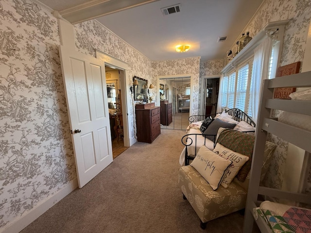 bedroom featuring light carpet, visible vents, and wallpapered walls