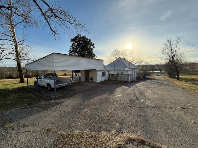 view of front of property with a carport and aphalt driveway