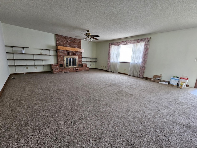 unfurnished living room with a ceiling fan, a brick fireplace, carpet flooring, a textured ceiling, and baseboards