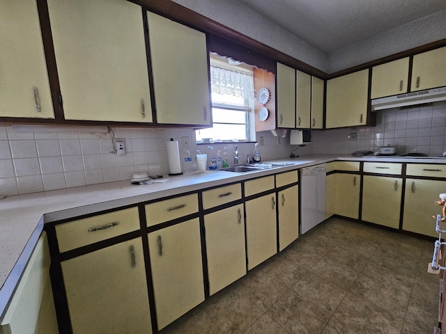 kitchen with decorative backsplash, white dishwasher, black electric stovetop, under cabinet range hood, and a sink