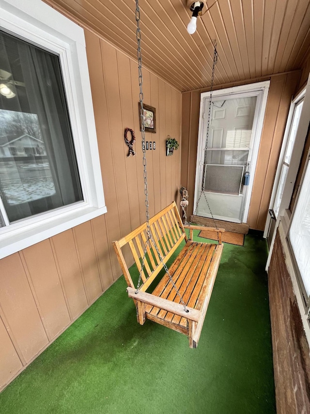 unfurnished sunroom with wood ceiling