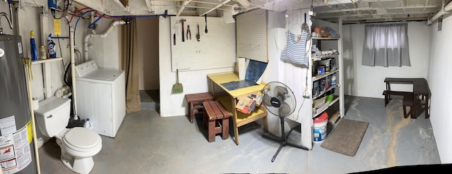 unfinished below grade area with water heater and washer / clothes dryer