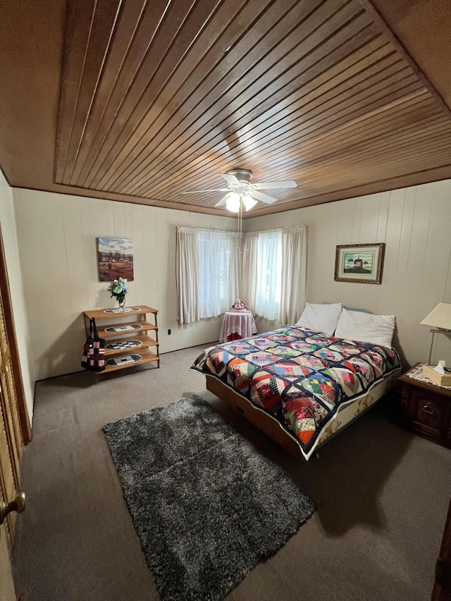 carpeted bedroom with wooden ceiling and a ceiling fan