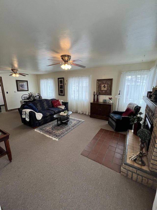 carpeted living room with a ceiling fan and a fireplace