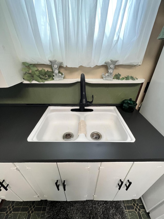 room details with dark countertops and a sink