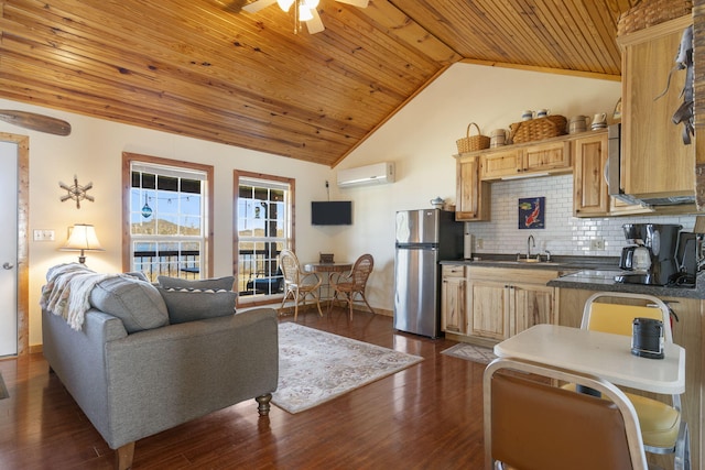 kitchen featuring ceiling fan, freestanding refrigerator, dark countertops, tasteful backsplash, and a wall mounted air conditioner