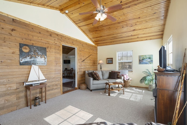 living area featuring ceiling fan, high vaulted ceiling, wooden walls, carpet floors, and wood ceiling