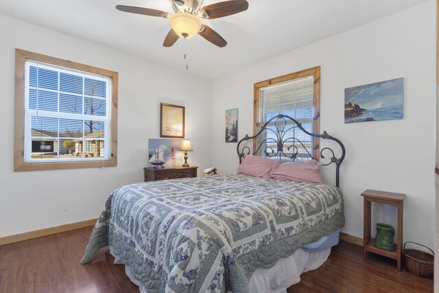 bedroom with a ceiling fan, baseboards, and wood finished floors