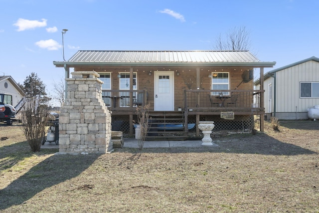 view of front of property featuring a porch and metal roof