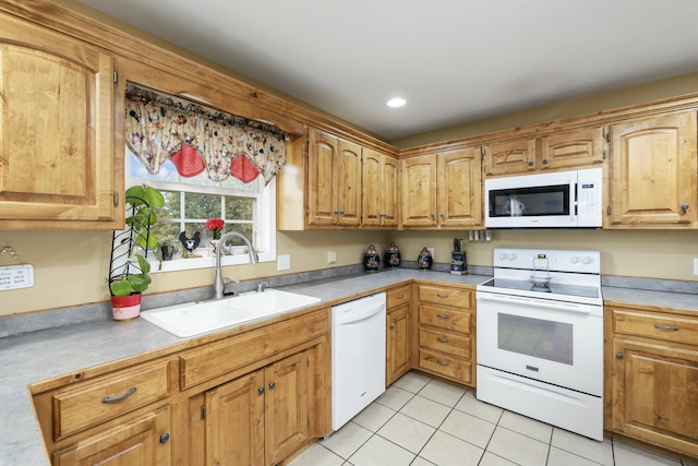 kitchen with light tile patterned flooring, recessed lighting, white appliances, a sink, and light countertops