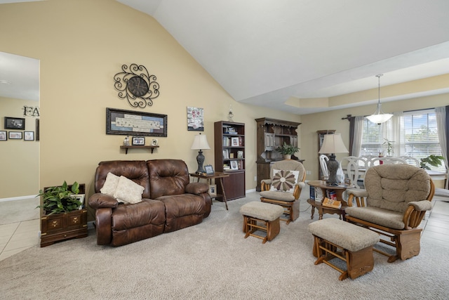 living area with carpet floors, tile patterned flooring, high vaulted ceiling, and baseboards