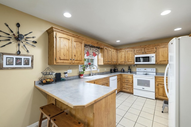 kitchen featuring white appliances, a peninsula, light tile patterned flooring, a sink, and recessed lighting