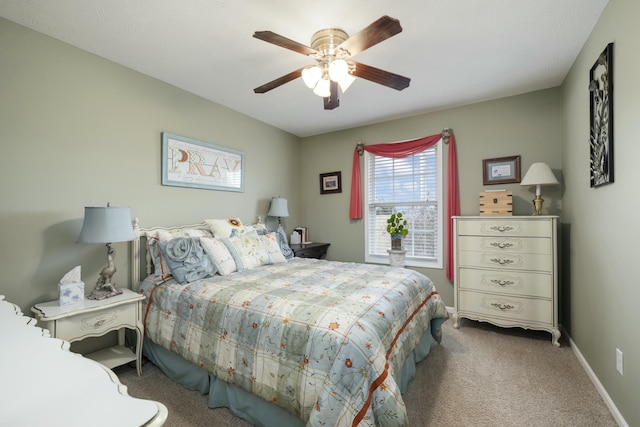 carpeted bedroom with a ceiling fan and baseboards