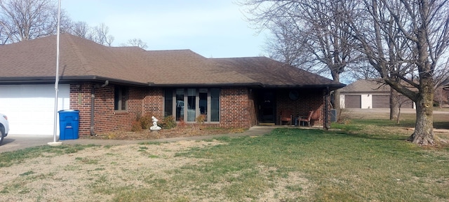 ranch-style house featuring a garage, a front yard, brick siding, and roof with shingles