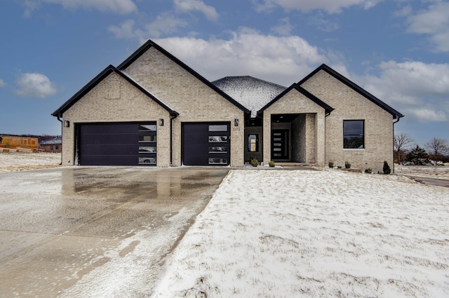 view of front facade featuring concrete driveway, brick siding, and an attached garage