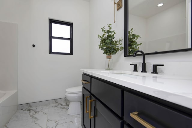 full bathroom featuring toilet, a tub, marble finish floor, vanity, and recessed lighting