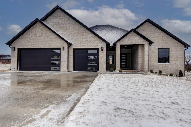 view of front of home featuring brick siding, driveway, and an attached garage