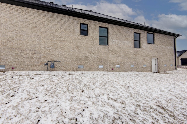 rear view of property featuring brick siding