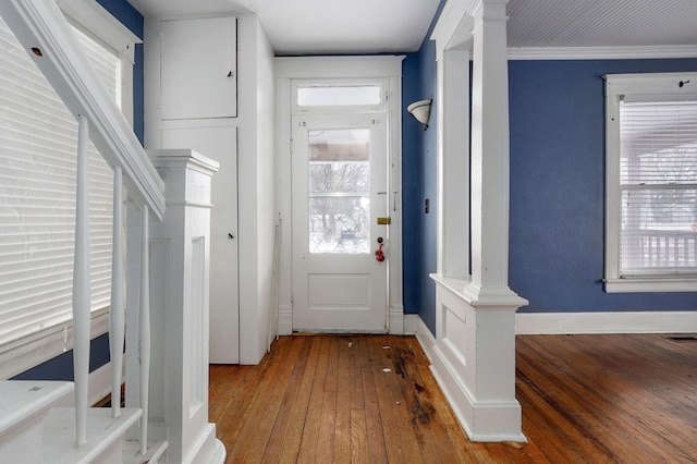 entryway with a wealth of natural light, baseboards, and hardwood / wood-style flooring