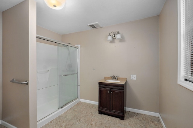 bathroom featuring a stall shower, baseboards, visible vents, and vanity