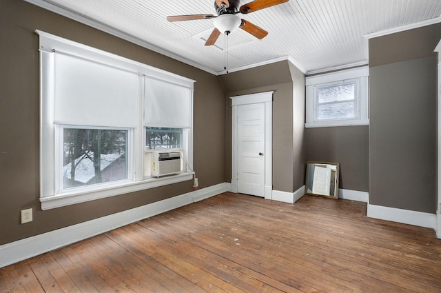 spare room featuring baseboards, wood-type flooring, ceiling fan, ornamental molding, and cooling unit