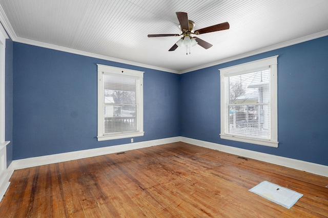 unfurnished room featuring visible vents, hardwood / wood-style floors, ornamental molding, a ceiling fan, and baseboards