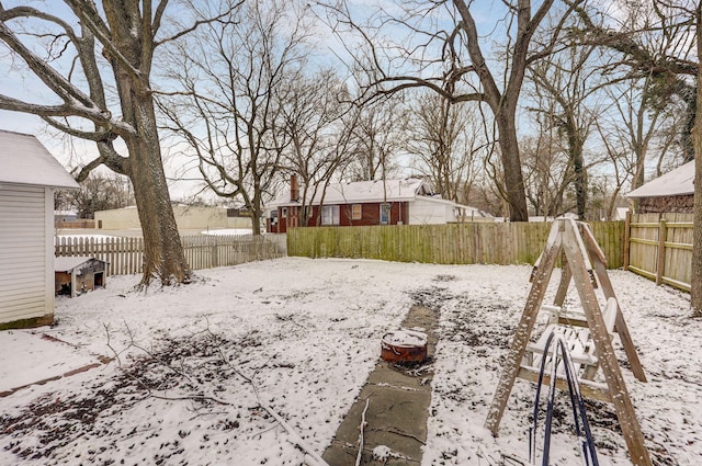 yard layered in snow featuring a fenced backyard