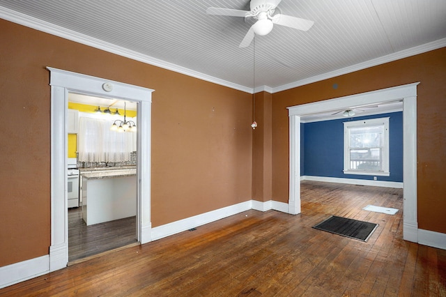 empty room featuring ceiling fan with notable chandelier, wood-type flooring, and crown molding