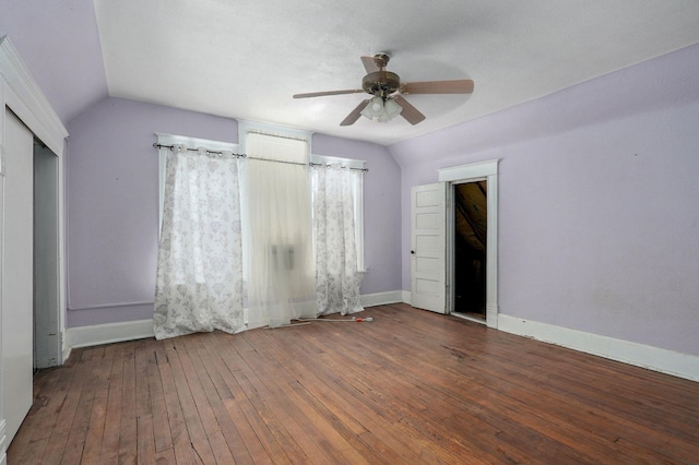 unfurnished room with lofted ceiling, hardwood / wood-style flooring, baseboards, and a ceiling fan