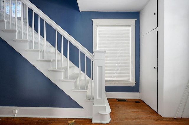 stairs featuring visible vents and wood finished floors