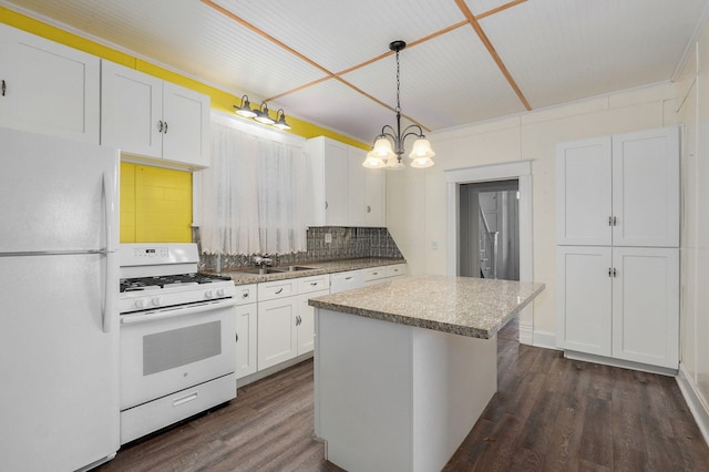 kitchen featuring white appliances, dark wood-style flooring, a kitchen island, white cabinets, and backsplash